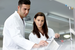 Two employees of a pharmaceutical company analyzing data