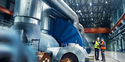 Close up picture of an engineer in front of a turbine in power plant